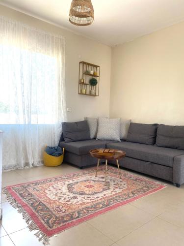 a living room with a couch and a table at The Roof in Kefar Blum