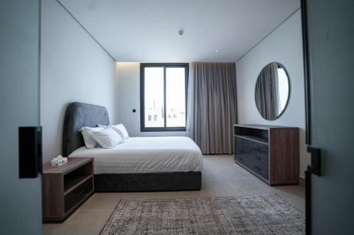 a bedroom with a bed and a dresser and a mirror at Paradise of North Riyadh جنة شمال الرياض in Riyadh