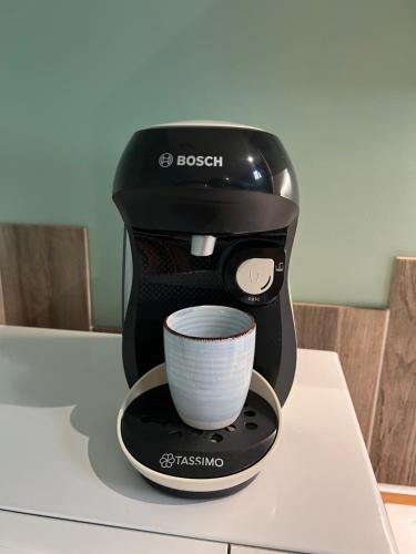 a coffee maker with a cup on a counter at Appartement Villa Saint Felix in Biermes