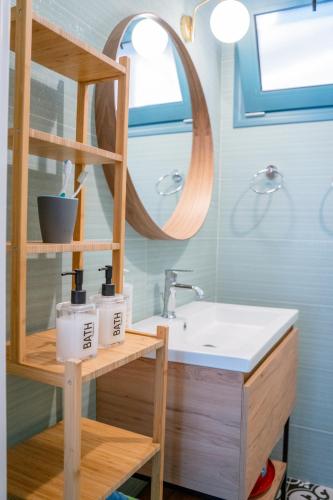 a bathroom with a sink and a mirror at Abuelita Cottage in Andipáta Erísou
