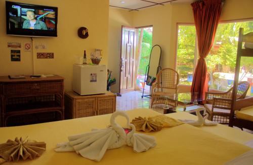 a room with a bed with towels on it at Deep Forest Garden Hotel in Puerto Princesa City