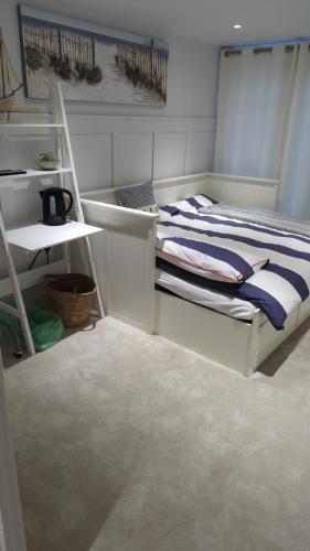 a bedroom with a bunk bed and a shelf at The Cosy Beach in Llanelli