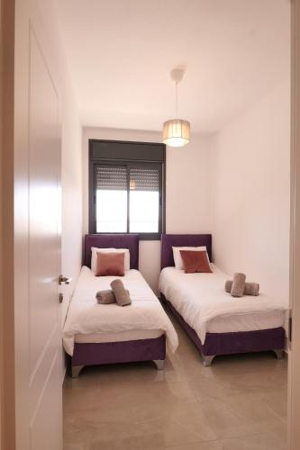 a bedroom with two beds and a window at 2BDR Suite#Next To The Market#Best Location in Jerusalem