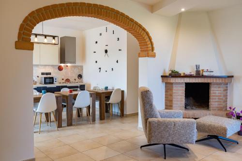 a kitchen and dining room with a table and a fireplace at B&B La Figuretta in Iesi