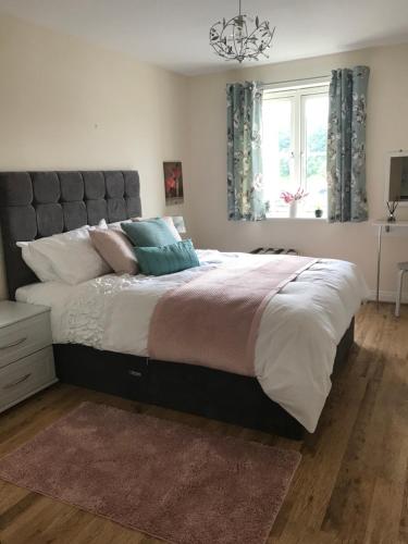 a large bed in a bedroom with a window at Swanning Off Whitby with Parking in Whitby