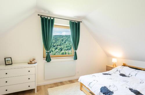 a bedroom with a bed and a window at Domek pod Magurką in Międzybrodzie Bialskie