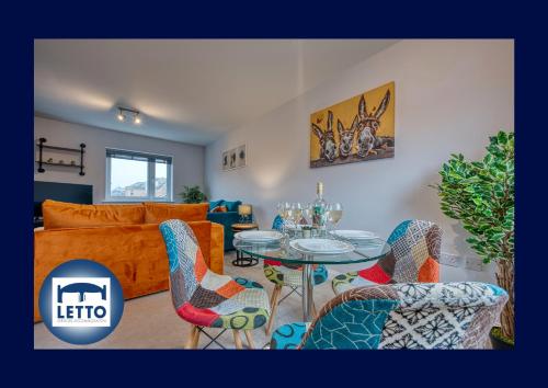 a living room with a table and chairs and a couch at Letto - Modern House I 5 guests I Free Parking in Peterborough