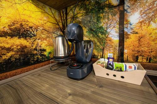 a blender sitting on top of a wooden table at 19th & 18th Floor Secure Apartments with Pool & Fitness & Parking included in price in Skopje