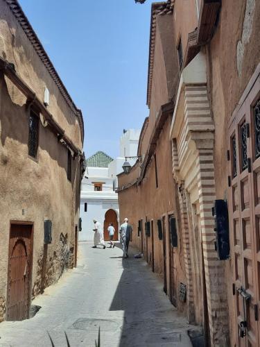 Un groupe de personnes se promenant dans une ruelle dans l'établissement Riad 1001 couleurs, à Marrakech