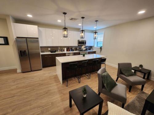 a living room with a kitchen and an open floor plan at Close to NYC, 10 Guest, Luxurious 3Bedroom Apartment in Union City