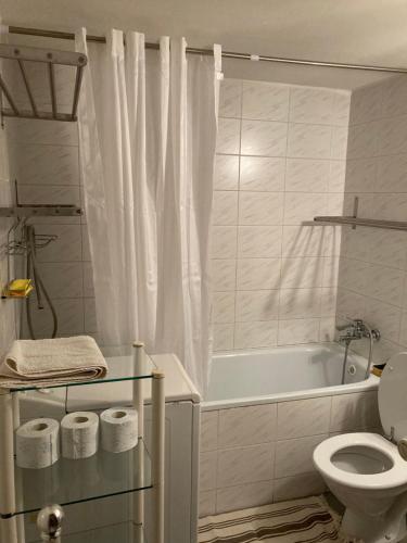a white bathroom with a tub and a toilet at U starkych in Poprad