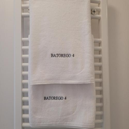 a towel with the words barbarosso on a towel rack at Apartamenty Batorego 4 in Bydgoszcz