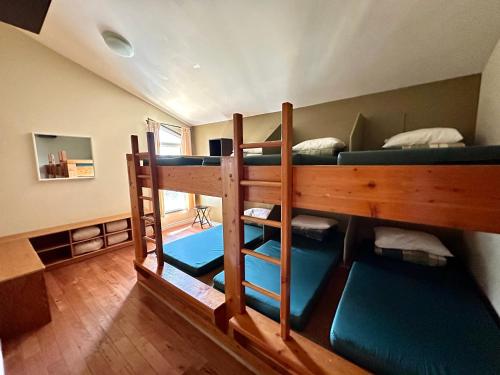 a group of bunk beds in a room at Canmore Alpine Hostel - Alpine Club of Canada in Canmore