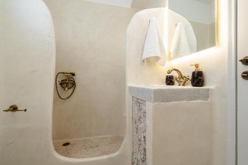 a white bathroom with a shower and a sink at Michael's apartment Filoti in Philotium