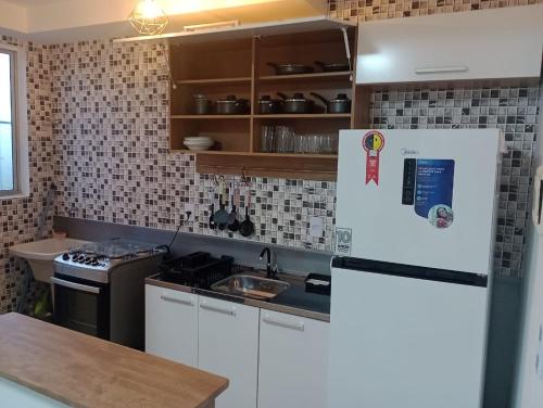 a kitchen with a refrigerator and a counter top at Resiliência House in João Pessoa