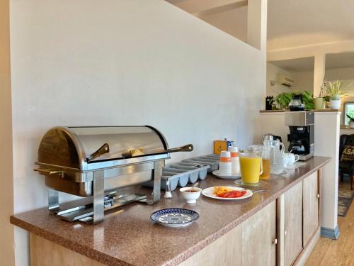 a kitchen with a counter with food on it at Castle Rock Country Inn in Ingonish Beach