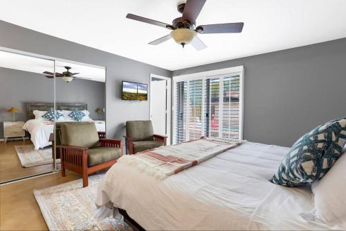 a bedroom with a bed and a ceiling fan at Pool, Fire Pit, Ping-Pong in Tucson