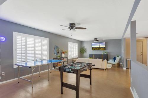 a living room with a table and a couch at Pool, Fire Pit, Ping-Pong in Tucson