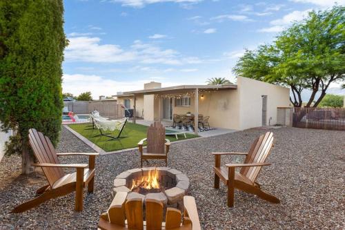 a backyard with two chairs and a fire pit at Pool, Fire Pit, Ping-Pong in Tucson