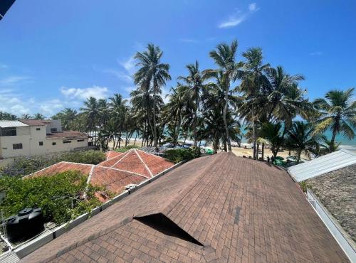 a roof of a building with palm trees in the background at Casa MIA in Cabarete