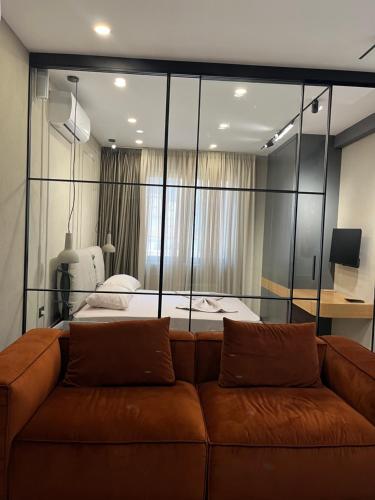 - un salon avec un canapé en face d'un lit dans l'établissement Fox Apartments, à Tirana
