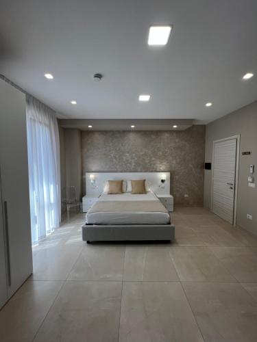 a bedroom with a large bed in a room at B&B VIRGILIO LAMEZIA AIRPORT in SantʼEufemia Lamezia