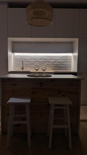 a kitchen with two wine glasses sitting on a counter at Apartament&SPA Lis&Las in Sobótka
