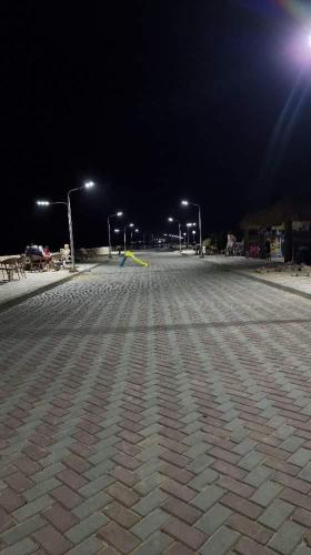 an empty parking lot at night with street lights at شاليه في قرية هيلو بيتش في الكيلو ٥٠ in Borg El Arab