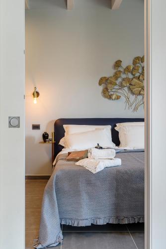 a bedroom with a bed with a painting on the wall at BORGO DEL FRANCO in Castellabate