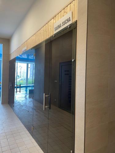 an entrance to a school building with a glass door at Apartament&SPA Lis&Las in Sobótka