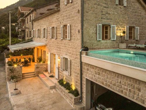 an external view of a building with a swimming pool at Villa Feliz in Kotor