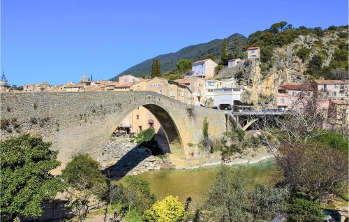 an old stone bridge over a river in a town at Nice Home In Marsanne in Marsanne