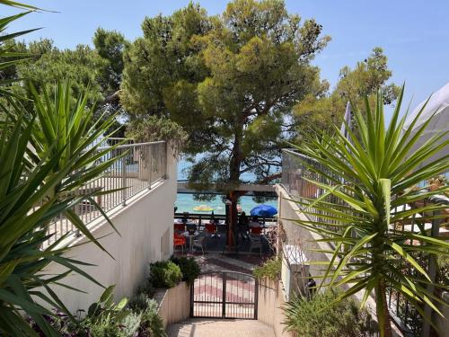 a view from the balcony of a villa with a pool at Beachfront Comfort Apartment NIVES in Tučepi