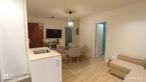 a living room with a couch and a dining room at Vista Mar in Viana do Castelo