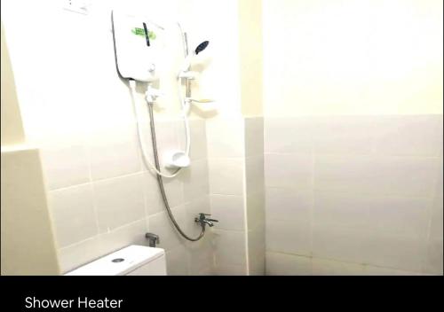 a shower in a bathroom with a toilet and a shower head at Condo Stay at Paranaque with Unlimited WIFI v3 in Manila