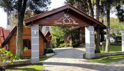 a pavilion in a park with a building at Hotel Cabana Jardim de Flores in Gramado