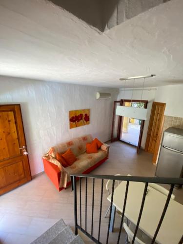 a living room with a couch at Villa Juniperus Porto Pino in SantʼAnna Arresi