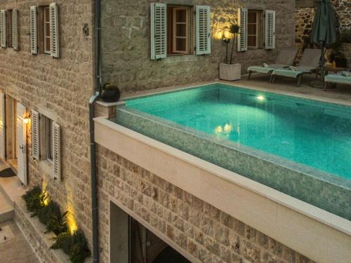 a swimming pool on the side of a building at Villa Feliz in Kotor