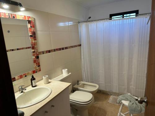 a bathroom with a sink and a toilet and a shower at La Recompensa House 