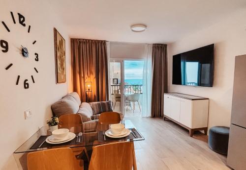 a living room with a couch and a table at Sapphire Riviera Residence in Adeje