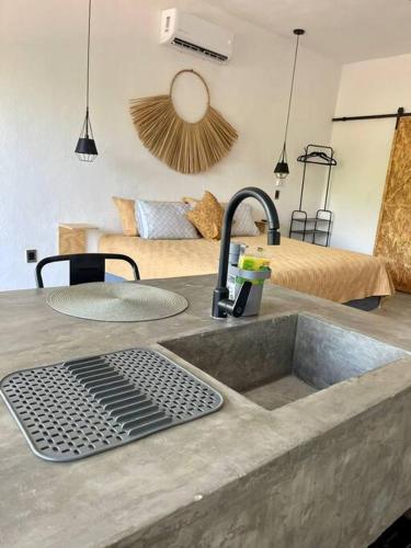 a kitchen counter with a sink and a sink at océano estudio 2 in Sayulita