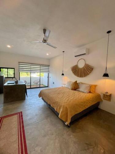 a bedroom with a bed and a desk in a room at océano estudio 2 in Sayulita