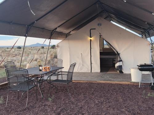 a tent with a table and chairs in it at Prairie Falcon in Valle