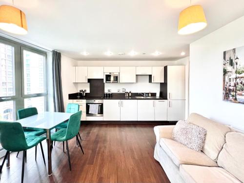 a living room with a table and a couch at Venice Court London 2Bedroom Apartment in London
