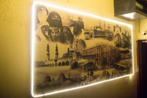a sign on a wall with a picture on it at cairo view hotel in Cairo