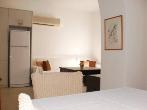 a kitchen and living room with a table and chairs at The Kamari Blue Dome house in Kampos Paros