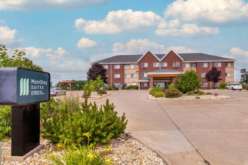 a building with a sign in front of a building at MainStay Suites Dubuque at Hwy 20 in Dubuque