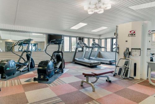 a gym with treadmills and elliptical machines at Comfort Inn in Manistique