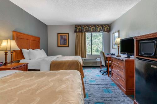 a hotel room with two beds and a television at Quality Inn & Suites Chattanooga West near Lookout Mountain in Chattanooga