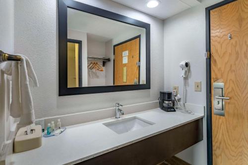 a bathroom with a sink and a large mirror at Quality Inn & Suites in Chattanooga
